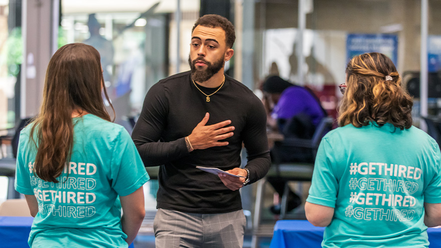student meeting employers at 24 career fair