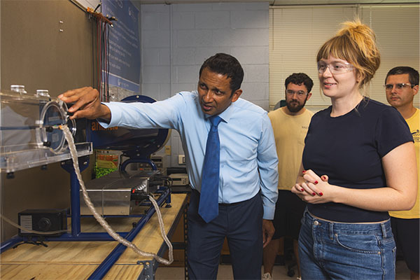 faculty member speaking to students in classroom setting