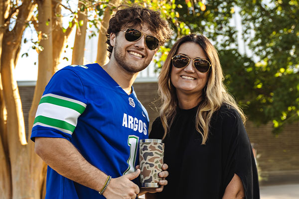 Student and Parent posing for a football game