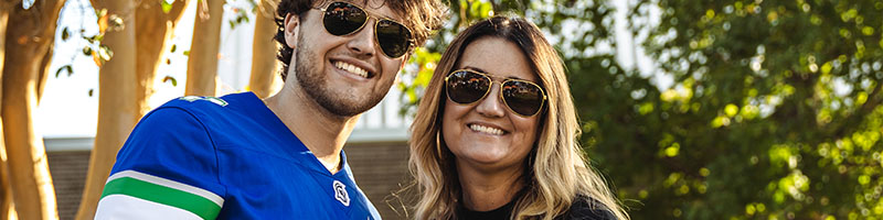 student posing with parent for tailgate
