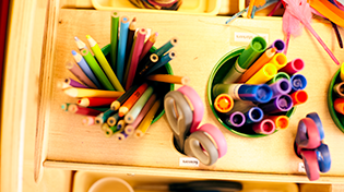 Various art and craft supplies displayed on table.