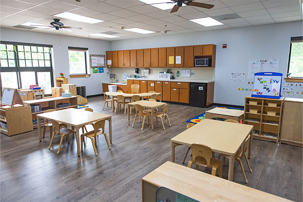 classroom with tables, chairs and activities