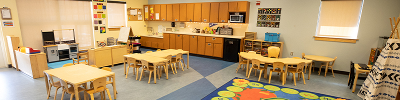 Classroom photo with tables and development toys