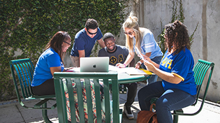 FSL students sitting at a table outside working together
