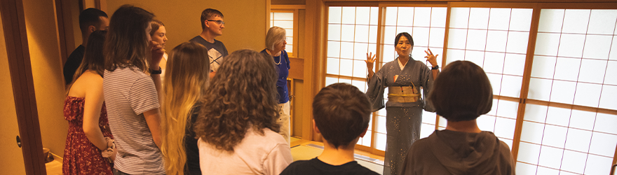 Students gathering around a presentation at the Japan House
