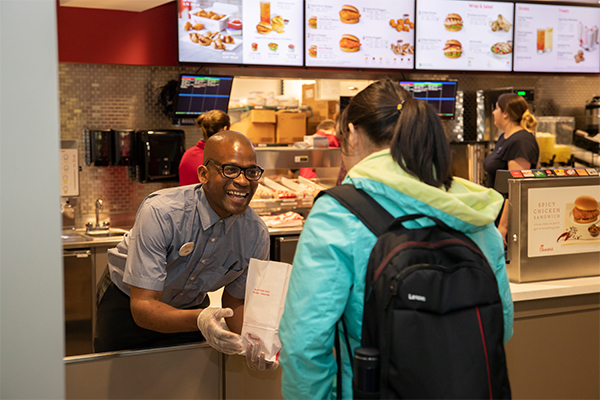Chickfila associate handing lunch to student