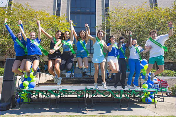 homecoming court jumping on stage