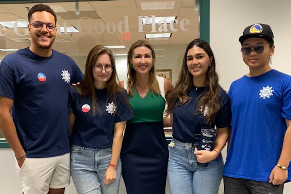 executive director posing with current students