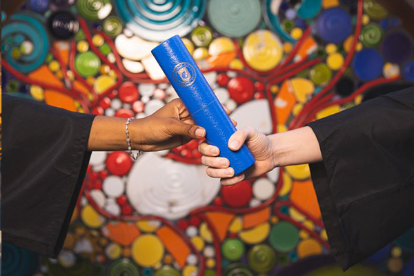 diploma being handed to student