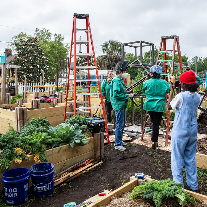 Students working on a community project with faculty