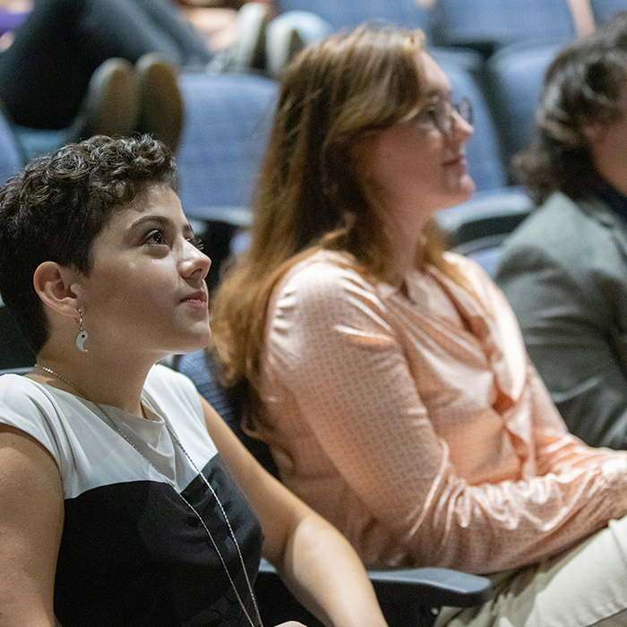 Students looking up at a lecture presentation