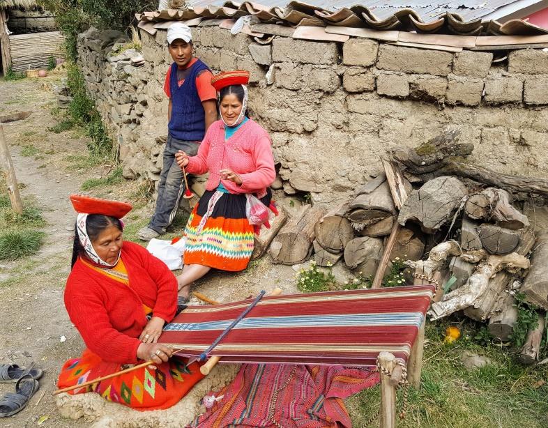 Peruvians weaving in street