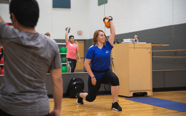 Group fitness instructor leading class