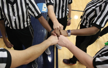 multiple hands in as sport officials