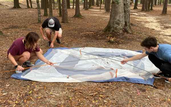 Students putting up a tent.