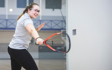 student playing racquetball
