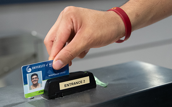 Hand swiping their Nautilus Card