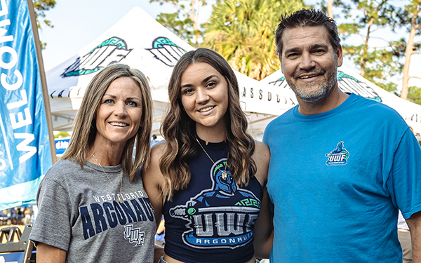 Three people at a tailgate