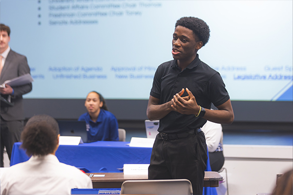 student giving speech at meeting