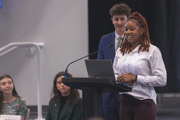 student speaking at sga meeting during open forum