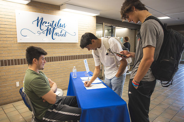 students voting at table