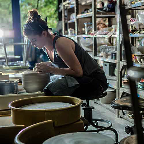 student molding clay in the cfpa ceramics studio