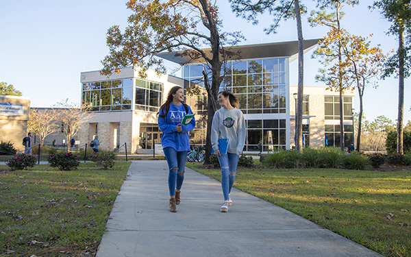 two students walking on the uwf main campus