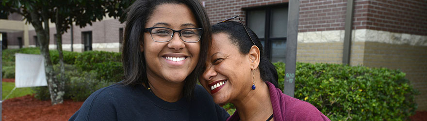 A UWF student and parent smile together on Move-In Day.