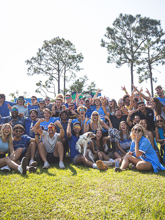 UWF students pose for a group photo at a football tailgate.