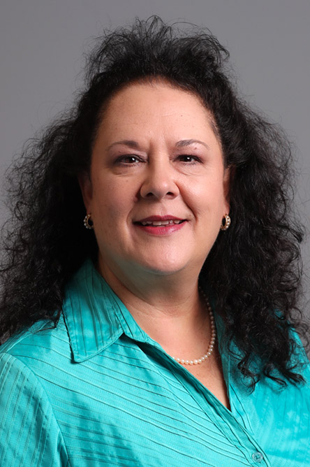 Monique Cossich indoor headshot.