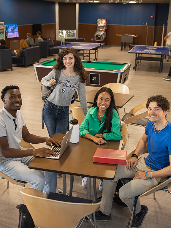 Students gathering in UWF Commons game room