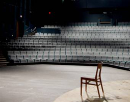 An empty chair on the stage of the Mainstage Theatre in the Center for Fine and Performing Arts on the UWF Pensacola campus.