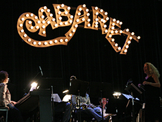 The set of UWF Theatres production of Cabaret featuring a light up sign