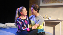 Lizzie and Danny sitting on their bed