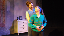 Pam and Nick standing in their bedroom