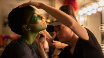 dents applying makeup for UWF Theatres production of The Little Mermaid
