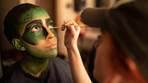 dents applying makeup for UWF Theatres production of The Little Mermaid