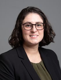 Sarah Stanford in an olive green blouse and black blazer.