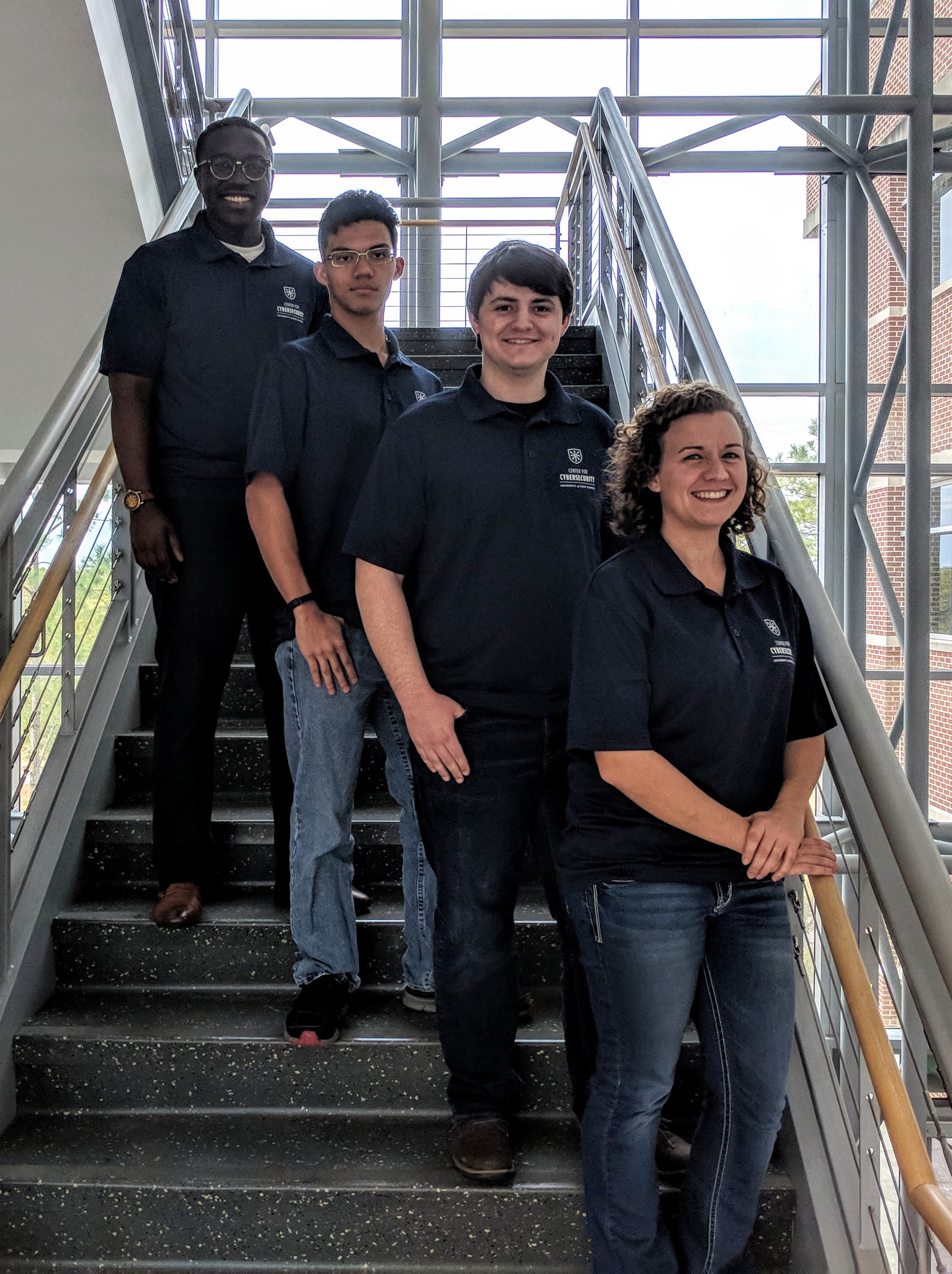 UWF Center for Cybersecurity ambassadors Basil Kuloba, Justin Fruitticher, Carson Wilber and Ashley Phillips