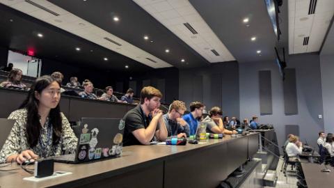 Students attending a lecture in an auditorium.