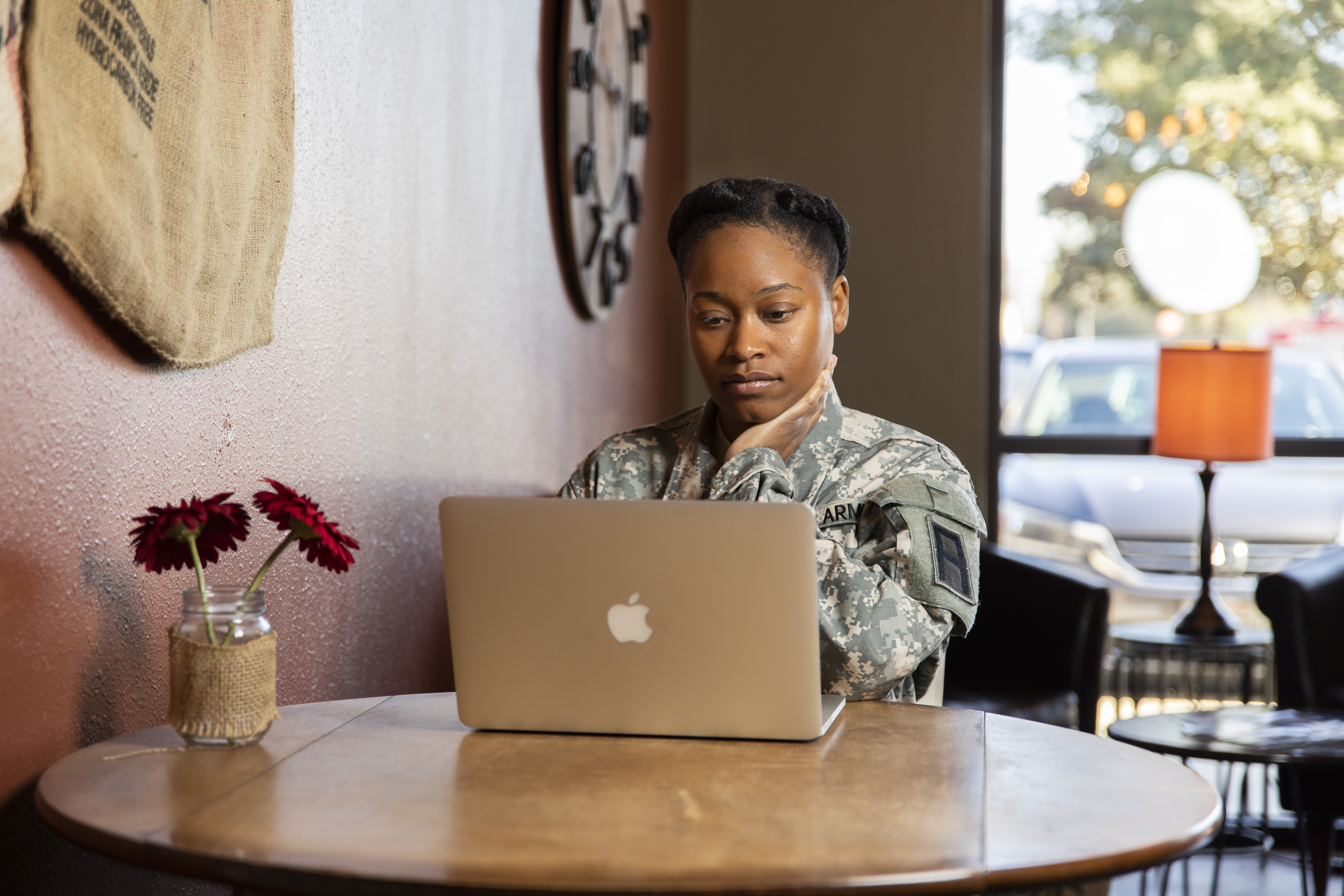 U.S. service woman looking at laptop.