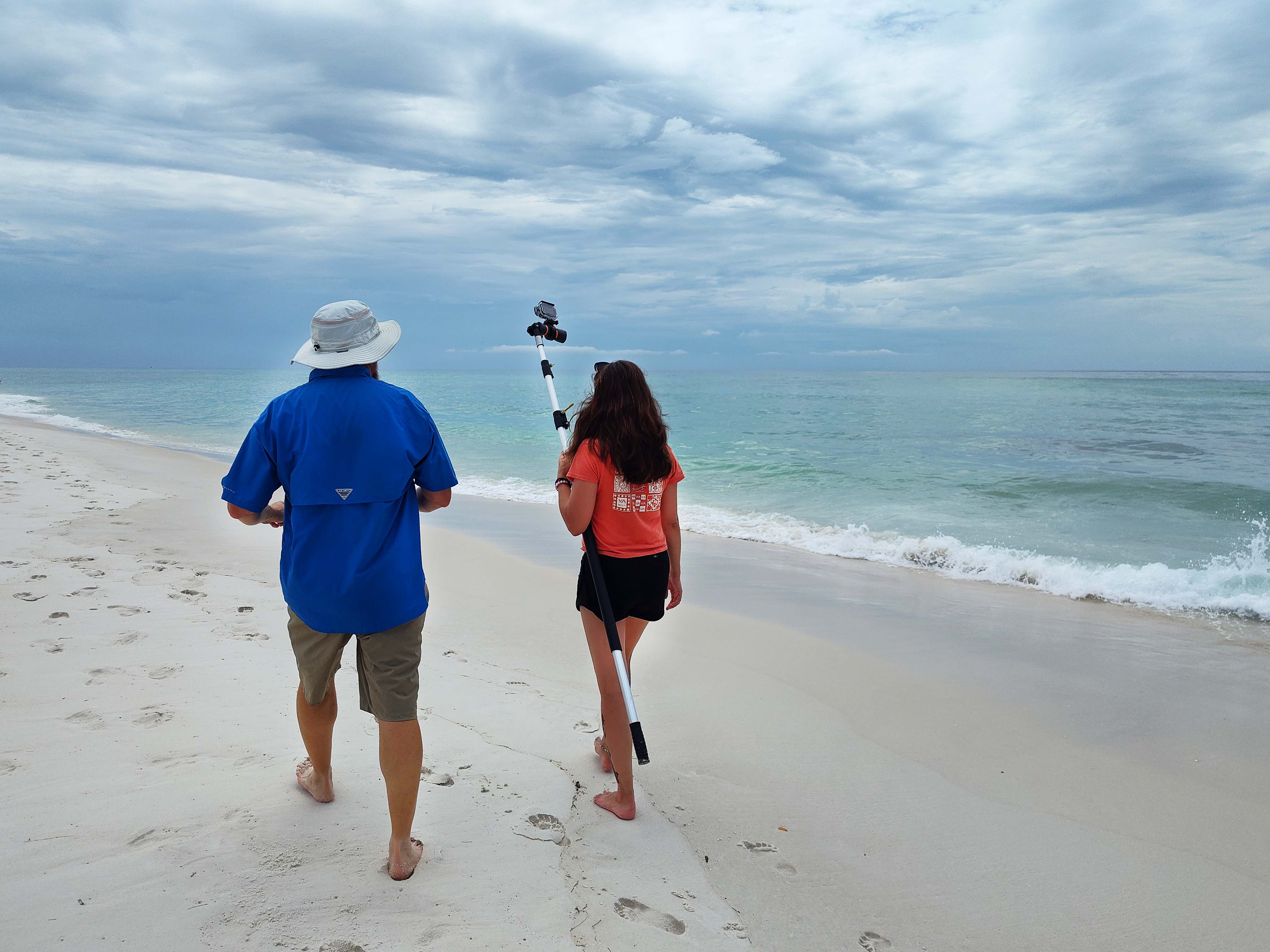 GIS research being completed by student and professor on the beach