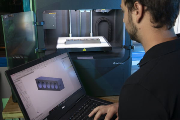 student sitting at computer looking at SolidWorks software