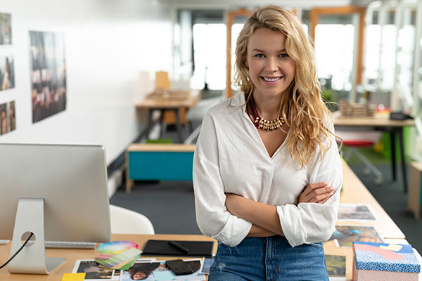 Graphic designer in office standing in front of desk