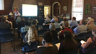 stakeholders listening to presentation in governor martin house