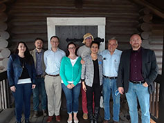 planning meeting committee posing in front of the panhandle pioneer settlement