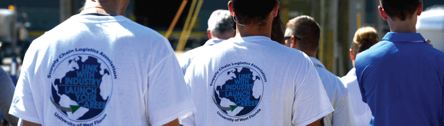 Two students wearing shirts that display a University of West Florida Supply Chain Logistics Association, Link with Industry Launch Your Career logo on the back of the shirt.