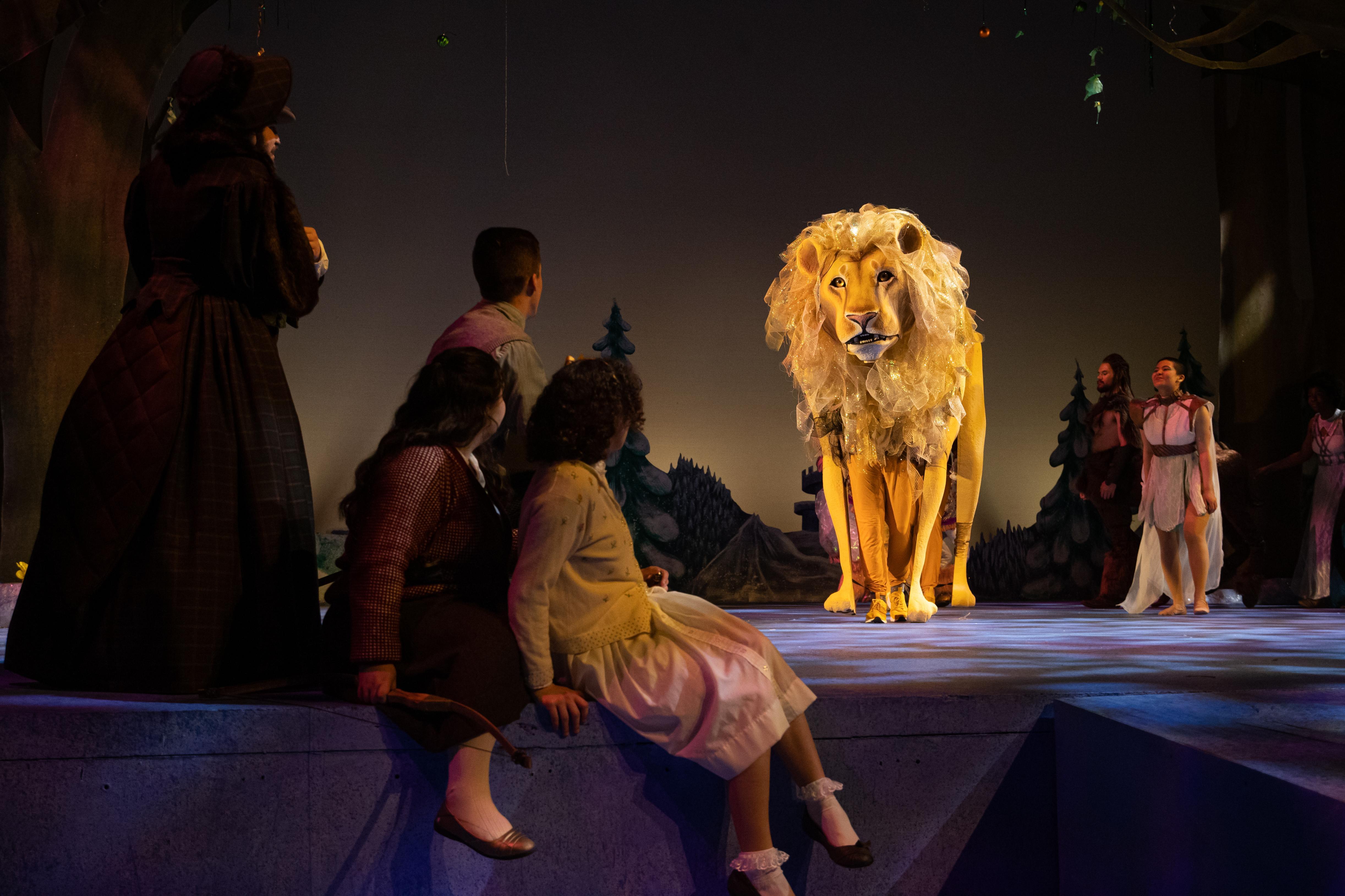 UWF students perform on stage a production of The Lion, Which and the Wardrobe