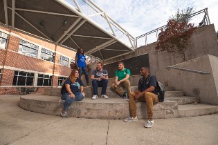 A group of students sitting on the stairs 