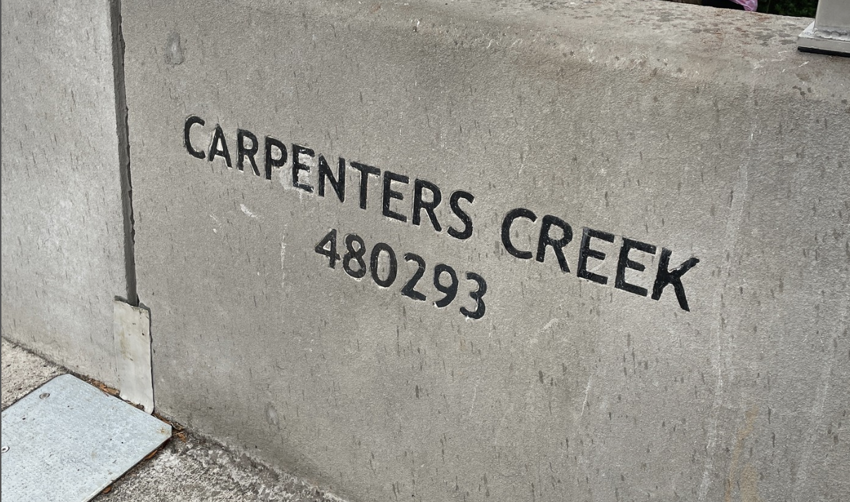A concrete sign that says Carpenters Creek